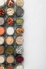 Vegan protein source. healthy vegetarian food. top view of seeds, nuts, peas, beans, rice, spelt, oatmeal on white background copy space