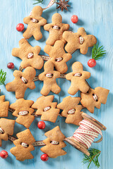 Handmade gingerbread cookies chain as Christmas ornaments.