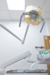 Dentist's chair, seen from the patient, with medical instruments ready for a review. dental light