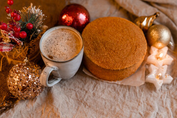 Obraz na płótnie Canvas coffee in a designer mug and homemade honey cake on a wooden table in a New Year atmosphere. cozy christmas, cozy winter. High quality photo
