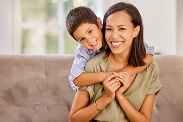 Boy, mother and sofa show love in home, happy and smile together in living room. Mom, child and couch love with happiness, hug and relax with affection in portrait at family home in Amsterdam