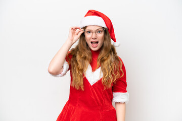 Young caucasian woman with Christmas dress isolated on white background with glasses and surprised
