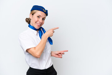 Airplane blonde stewardess woman isolated on white background pointing finger to the side and presenting a product