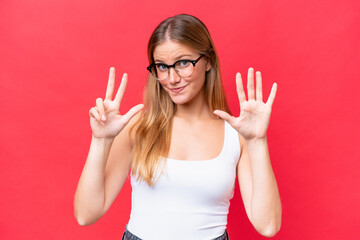 Young beautiful woman isolated on red background counting eight with fingers