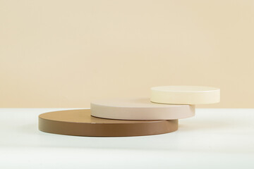 3d circle podium with various sizes, earth tone color and some white, with brown and white background