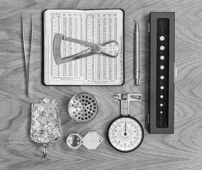 Diamond and Jewellery Tools on Wood Background. 