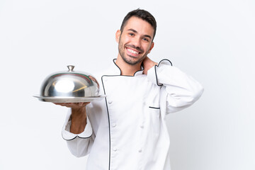 Young chef with tray isolated on white background laughing