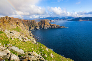 Fototapeta na wymiar Norwegian mountainous coast with a rainbow