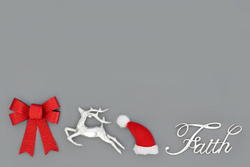 Christmas faith concept with sign, santa hat, reindeer and red bow on grey background. Festive tree...