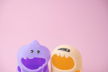 children's monsters for Halloween on pink and orange background , the concept of a children's holiday