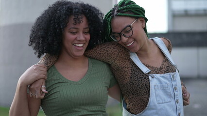 Two happy black Brazilian women celebrating life together. South American hispanic female friendship hugging laughing and smiling. Friendship authentic real life laugh and smile - Powered by Adobe