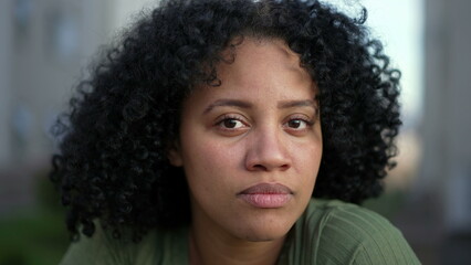 Portrait face of a young black woman looking at camera. A hispanic South American Brazilian adult...