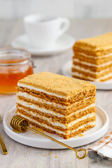Honey cake on a white plate. Delicious healthy dessert. Selective focus