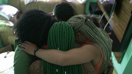 African American family hugging each other at home. A hispanic South American group of friends embracing