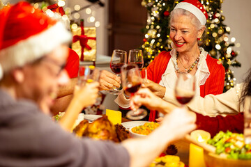 Multi-generation family toasting at Christmas dinner.Holiday celebration concept with happy family sharing winter time together at home.
