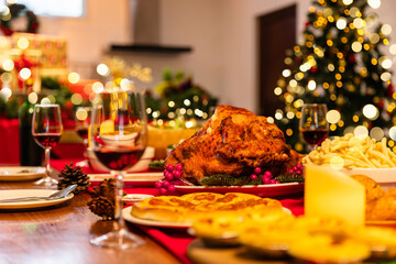 Family have a celebration dinner in party with wine, champagne on Merry Christmas Eve Xmas on holiday at home. Roasted Thanksgiving Turkey with Side Dishes.Thanksgiving Celebration .