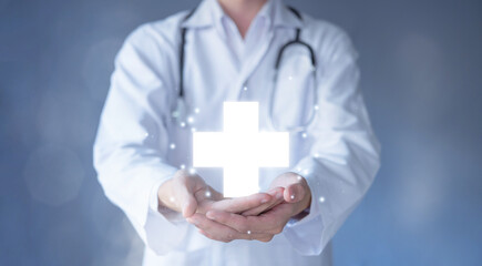 Red cross on hand of doctor with stethoscope. Medical technology and Healthcare treatment to...