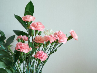 Bouquet of small decorative roses on a colored background. Greeting card with a bouquet of flowers