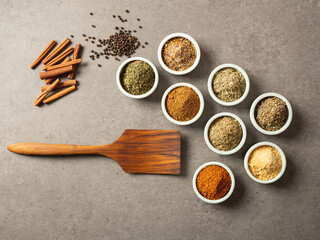 Various spices and cooking utensils in small bowls