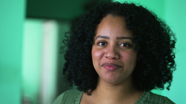 Portrait of a hispanic black latina woman with curly hair looking at camera. An African American girl