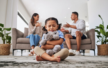 Parents, fighting and sad girl in living room with teddy bear for support or comfort. Family,...