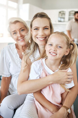 Happy woman in family, home with grandmother and girl child portrait together on sofa in Dublin. Elderly grandma in lounge with women, mama in living room holding daughter and love on mothers day