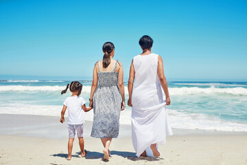 Children, family and beach with a girl, mother and grandmother enjoying the sea or ocean view while...