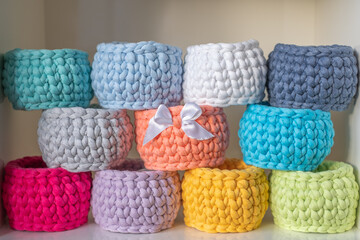 background of close-up of a beautiful colourful crochet baskets. Handicraft advertising.  Nice hobby in the winter evenings. Sustainable, organic lifestyle advertising. place for your text