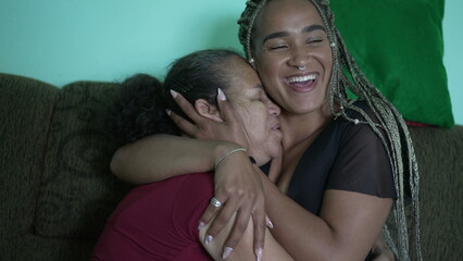 Hispanic latina older mother and adult daughter together love and embrace. Brazilian people together showing love