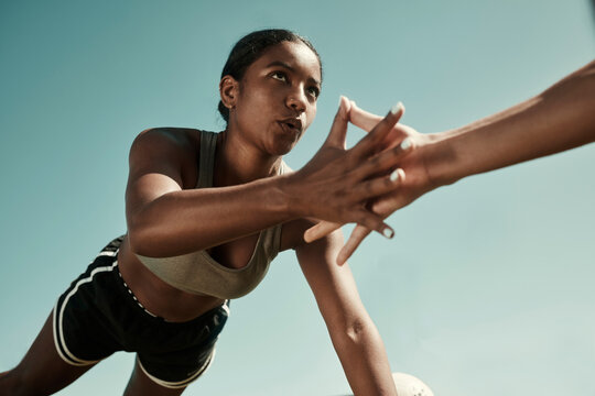 Teamwork, fitness and high five doing exercise in city, holding hands with workout partner. Health, support and black woman exercising with friend. Training, motivation and collaboration in sports