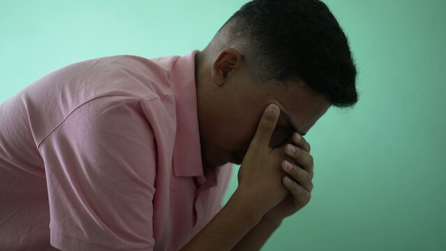 One Hispanic Young Man Suffering From Mental Illness Covering Face Remembering Trauma