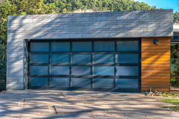 Modern detached garage exterior with frosted glass panels on garage door- Lake Austin, Austin, Texas