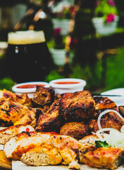 Shish kebab with chili sauce and dark beer