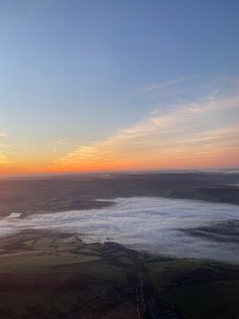 View flying over Peak District at sunrise on a foggy morning