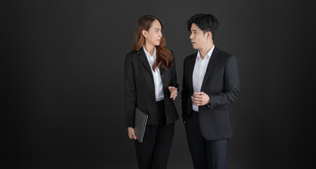 Business men and business women stand to talk business with smiling.