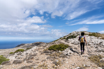 Fototapeta na wymiar middle-aged woman walking along the path, Puig des Teix summit, 1064 meters,Valldemossa, Majorca, Balearic Islands, Spain