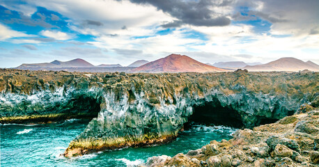 Fototapeta na wymiar Amazing view of lava's caves Los Hervideros and volcanoes in Lanzarote island, popular touristic attraction. Location: Lanzarote, Canary Islands, Spain. Artistic picture. Beauty world.