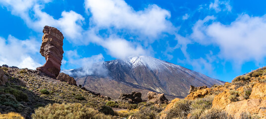 Amazing view of unique Roque Cinchado rock formation with famous Pico del Teide in the background on a sunny day, Teide National Park, Tenerife, Canary Islands, Spain. Artistic picture. Beauty world. 