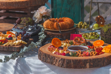 Sunny event at beach salon with cheese board and italian food on table with pasta
