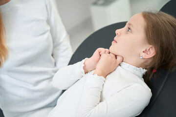 Scared little patient looking at pediatric dentist