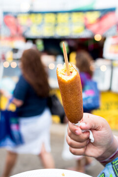 Biracial Woman Eating A Corn Dog At The State Fair