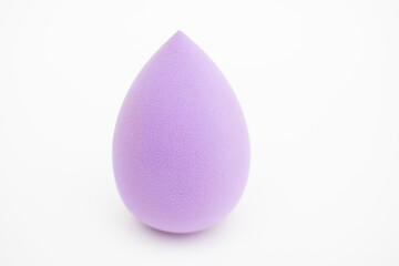 Purple egg make-up blender sponge or cosmetics, closeup.
