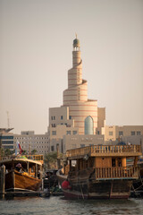 Doha,Qatar- April 24,2022 Traditional boats called Dhows are anchored in the port near the Museum of Islamic Art Park.