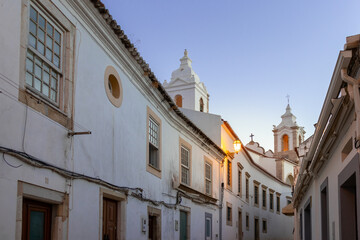 Fototapeta premium Portugal, August 2022: Street with white buildings at night, Lagos, Algarve, Portugal