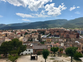 Fototapeta na wymiar Montblanc, Spain, June 2019 - A view of a large building with a mountain in the background