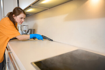 Lady actively cleans contaminated surfaces with instrument