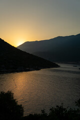 Landscape at sunset on a beach with mountains in the background in Turkey.