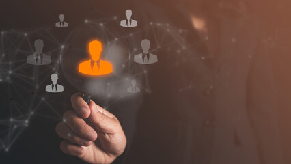 hand holding magnifying glass working on human resource management icons, focus to manager icon with staff icons for human development, leadership, relationship, target group concept