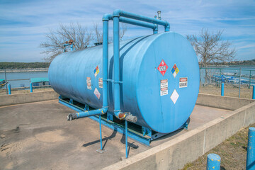 Austin, Texas- Blue propane tank with warning signs stickers at Lake Austin