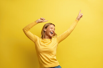 Excited Woman Rejoicing Isolated. Portrait of Overjoyed Girl Standing with Raised Hands and Shouting Yeah, I'm Winner, Rejoicing Victory, Success. Studio Shot Isolated on Yellow Background 